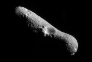 Image of the asteroid Erros, which looks like an oblong shape with a crater near the center